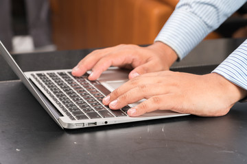 hands typing on notebook