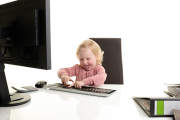Fototapeta na wymiar kleines blondes Mädchen am computer