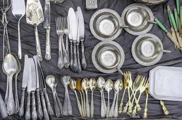 collection of cutlery on a street market