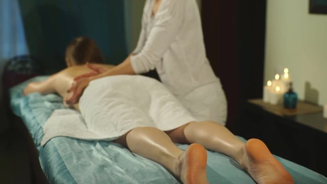 woman getting a back massage hands