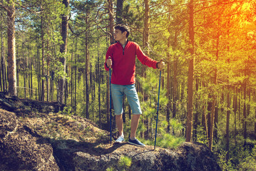 young man walking along in the forest.