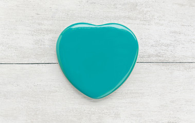 Obraz premium Green heart shape on white wood background