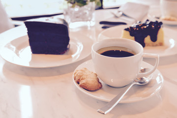 Coffee and cake on white marble table