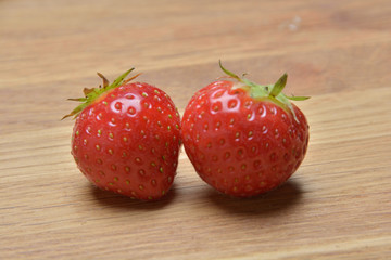 Ripe strawberries on wooden background