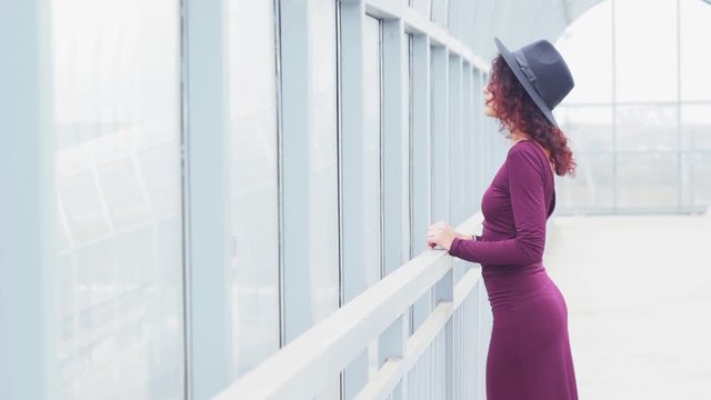 Beautiful curly-haired woman in a long dres