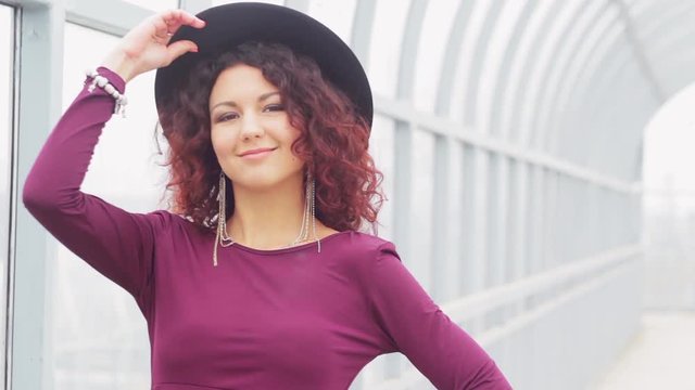 Beautiful curly-haired woman in a long dres