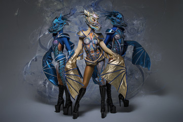 Women with beautiful dragons body-art, masks and wings