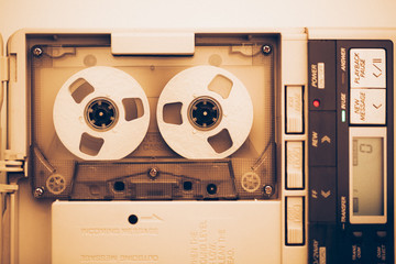 vintage audio tape compact cassette, sepia tone with artistic film noise