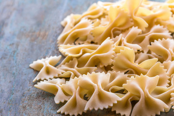 Farfalle pasta on the wooden base.