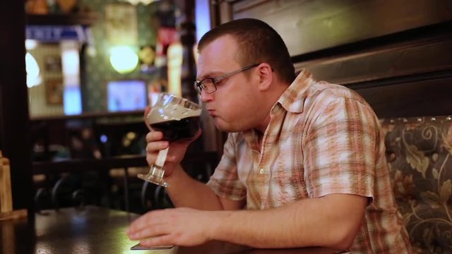 Man Drinking Beer In Bar