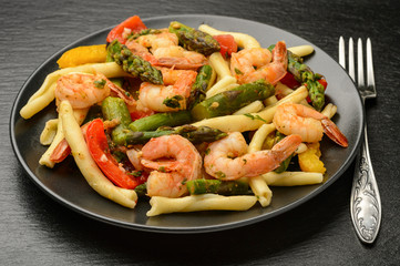 Italian pasta with shrimps, asparagus, paprika and tomatoes.