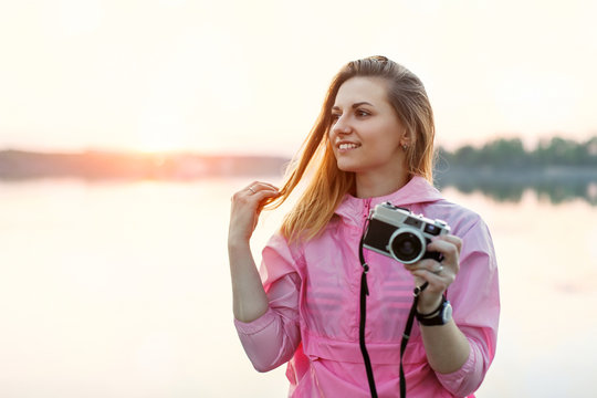 Hipster woman takes pictures outdoors