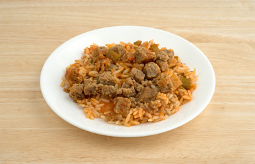 Rice peppers and beef chunks on a white plate