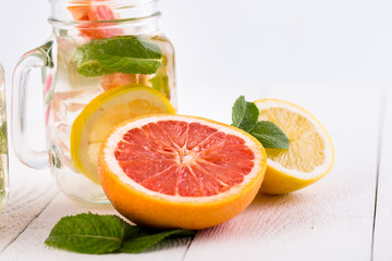 Homemade healthy smoothie with grapefruit and lemon in jar.