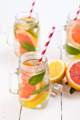Homemade healthy smoothie with fresh fruits and ice in jar.