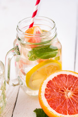 Homemade healthy smoothie with fresh fruits and ice in jar.