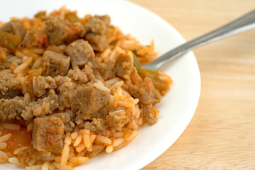 Rice peppers and beef chunks on a plate with fork