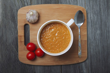 Tomato gazpacho soup with cherry, garlic and a spoon. Top view