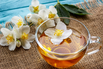 jasmine tea and jasmine flowers on  wooden background