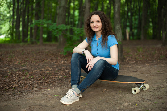 young woman with skating board at the park