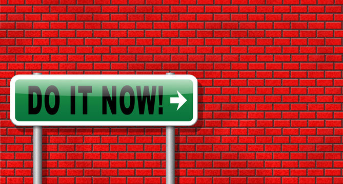 Do it now, it is the right time for real action. Act and dont waste time road sign with text. In front of brick wall.
