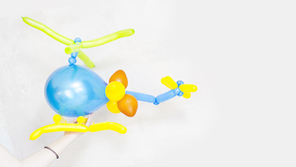 Colorful children's party fancy balloon in helicopter shape on white background. Children's party balloons. Balloons shape. Fancy balloon in helicopter shape. Colorful birthday balloons. Baby balloon. © Hotay