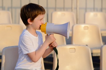 Little football fan with megaphone