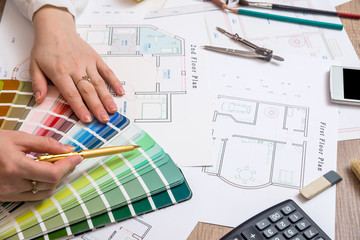 architects hands working with drawing sketch home, color sample and other working tools