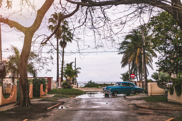 Old Car in front of the Cuban Ocean