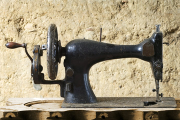 vintage  manual sewing machine made of metal with painted design