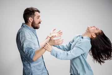Portrait of happy couple on gray background