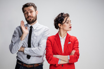 The sad business man and woman conflicting on a gray background