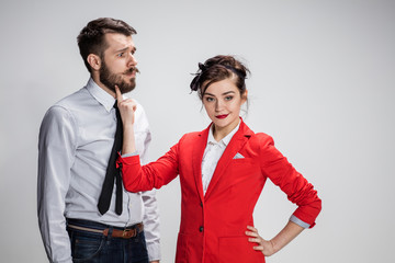 The business man and woman communicating on a gray background