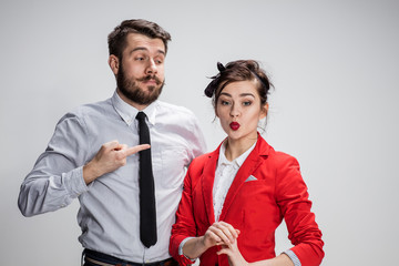The business man and woman communicating on a gray background