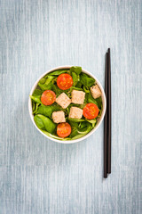 Vegan tofu salad with tomatoes and lamb's lettuce