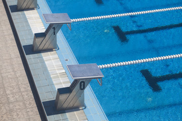 Photography of lanes of a competition swimming pool with water