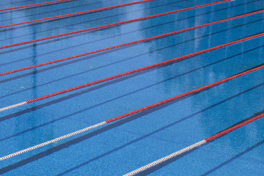 Photography of lanes of a competition swimming pool with water