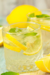 Refreshing drink with lemon, ice and mint