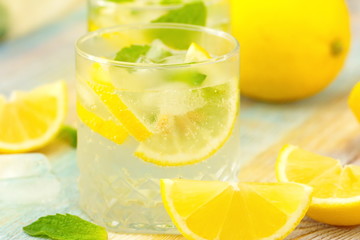 Refreshing drink with lemon, ice and mint