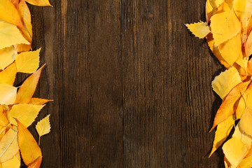 Naklejka na ściany i meble Autumn leaves on wooden background