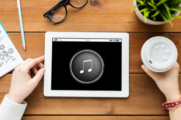 close up of woman with tablet pc on wooden table