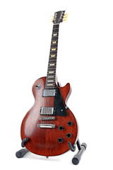 Obraz premium Brown electric guitar on a stand, isolated on white