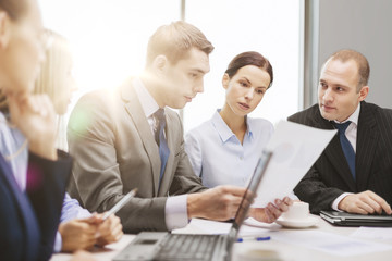 business team with laptop having discussion