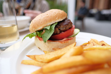 Hamburger and fries at restaurant table