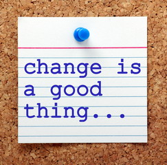 The phrase Change is a Good Thing on a note card pinned to a cork notice board as a reminder to...