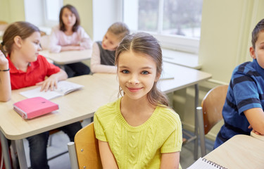 student girl with group of school kids in class