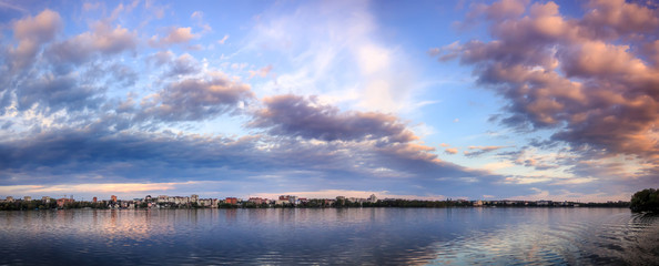 Fototapeta premium Fascinating Landscape. Majestic sunset. dramatic colorful clouds over the lake, reflected in the water. wonderful view. use as background. color in nature. series. toned