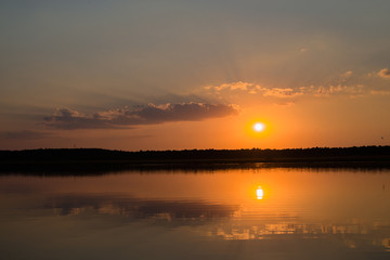 orange sunset reflected in water