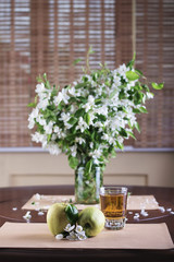 glass of apple juice and fresh apples on the wooden table with b