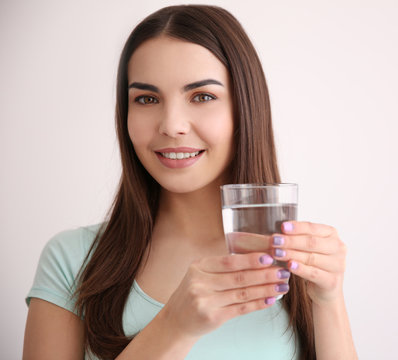 Beautiful girl drinking water